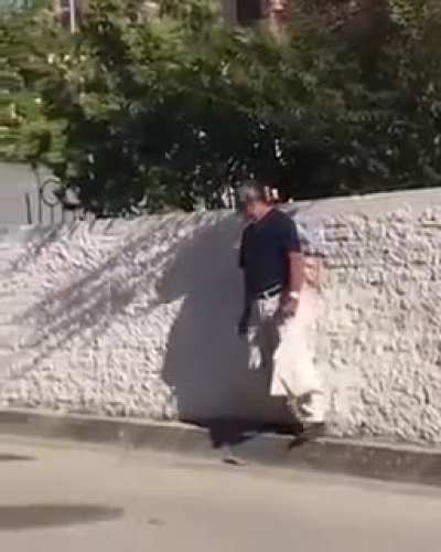 Old man walking on the sidewalk