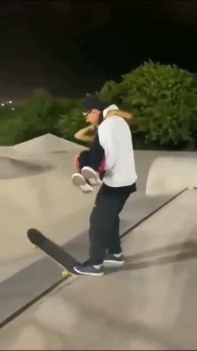 Skateboarding and lifting a girl