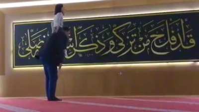 daughter plays with her father while he prays