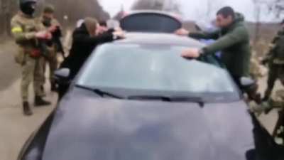 Ukranian soldiers stop a car for a security check.