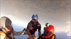 Skydiver gets knocked out cold before his chute is opened and survives.