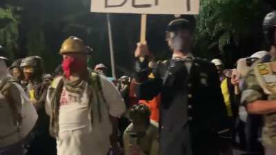 Wall of US miltary vets in Portland last night, standing at parade rest in solidarity