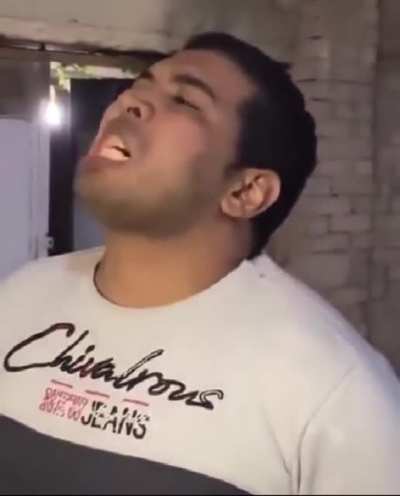 Guy eats burning coal