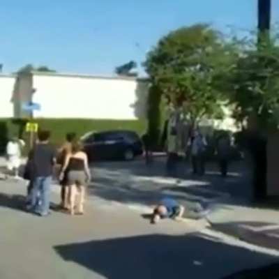Guy drags a helpless person across the street then gets what's coming to him