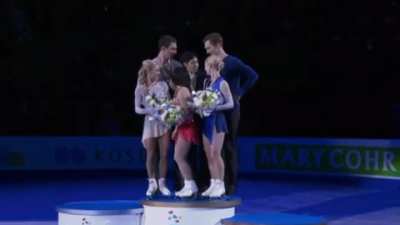 Second and third place winners lift up the first place winner to give him prominence. Cute!