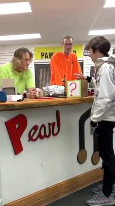 Kid tries to sell a "mystery box" to a shop keeper