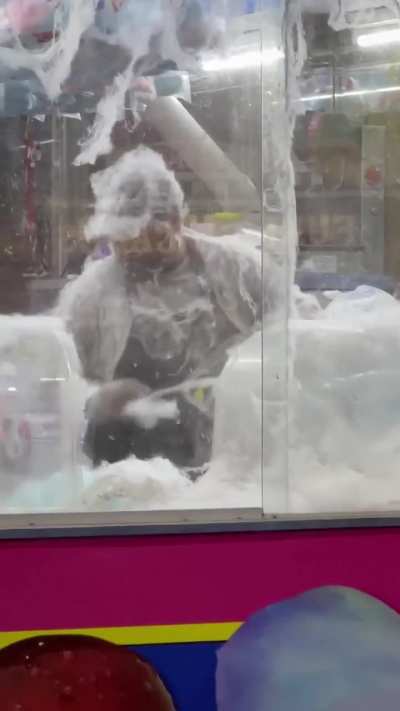 Man struggling with the cotton candy machine.