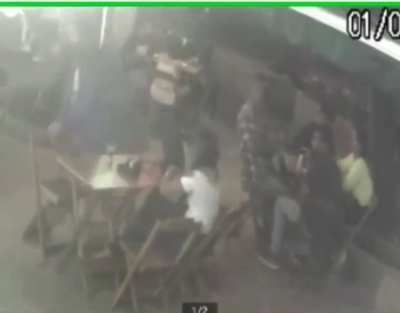 A man hits a woman at the bar and takes change from 4 men who were at the next table.