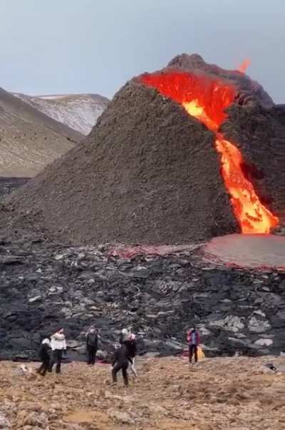 People casually playing volleyball at the volcano in Fagradalsfjall, Iceland.