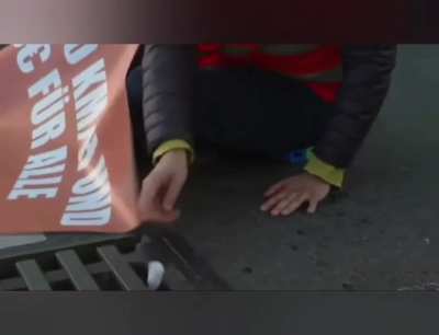 climate activist in Germany glue herself to the streets for the environment