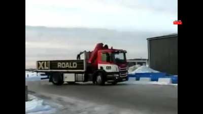 This truck entering a garage on an icy road...