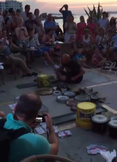 man makes electronic music with pans, buckets and other items