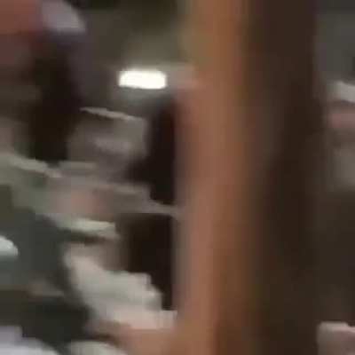Keanu lifting the equipment with the crew on set