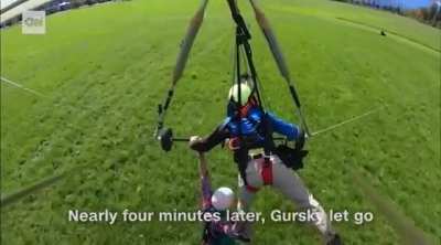 Pilot forgets to hook tourist to handglider, he hangs on for life