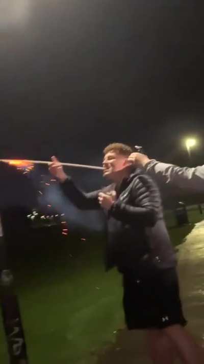 Holding a firework with the teeth