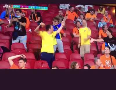 Dutch fan in the stands congratulating and handshaking a Ukraine fan after Yarmolenko’s stunner of a goal
