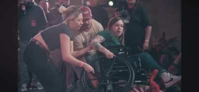 A girl in a wheelchair crowd surfing at a Kublai Khan show