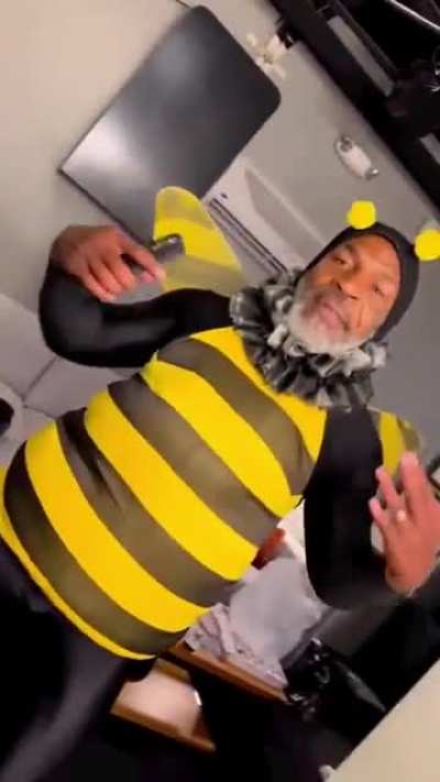 Mike tyson wearing a bee custom and having a good time