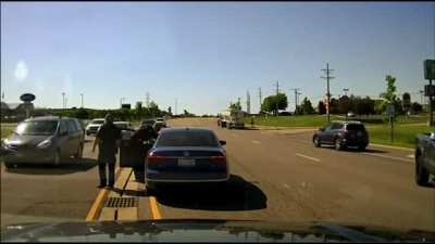 Man jumps into moving car to somebody