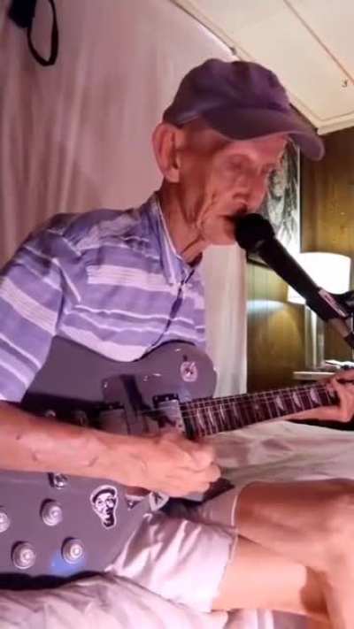 Just practicing his guitar.