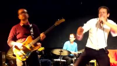 Bass player hits the singer.