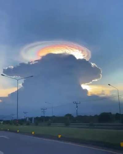 I'm no Meteorologist, but this appears to be a Cumulonimbus Cloud crowned by a Lenticular Cloud.