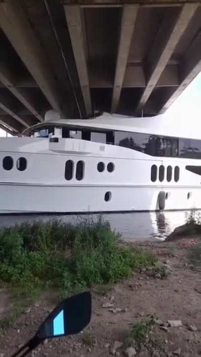 To sail a super yacht under a low bridge during high tide