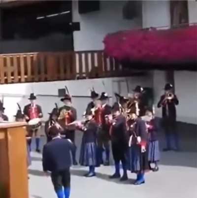 A craftsman uses a nail gun in sync with the orchestra’s rhythm to avoid causing any disruption