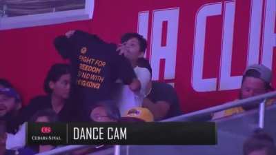 This kid baiting the broadcast into flashing a "Fight for freedom stand with Hong Kong" sign on TV and then the cameraman pans away.