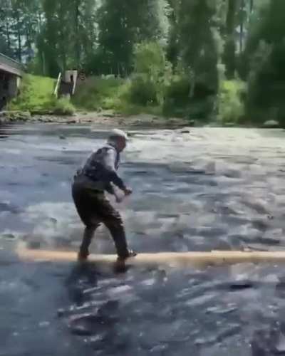 retired logger rides a log like a boss