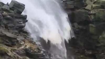 ? A waterfall being blown backwards by high winds