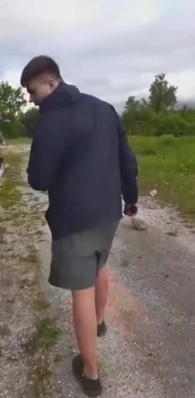 My friend blowing spray paint up in his face