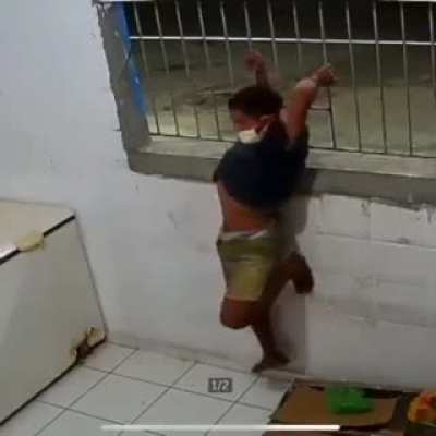 Thief has been captured on CCTV forcing himself through burglar bars.