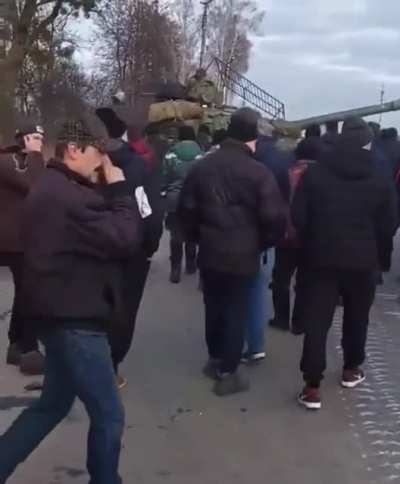 Ukrainian civilians stop Russian occupants' tank with bare hands