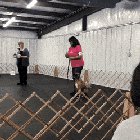 The dog is supposed to run up in front of her and sit.