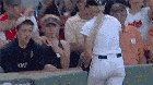 Guy give baseball to a young kid