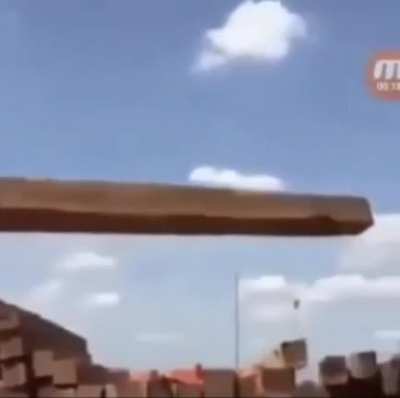 An excavator using a rope and lever technique to move materials it wasn’t originally designed to move
