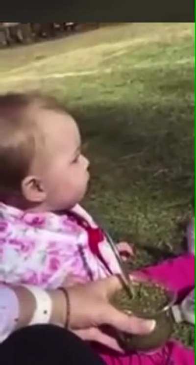 Baby trying herbal tea for the first time