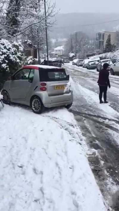 idiot overtaking a car on a steep hill covered in snow