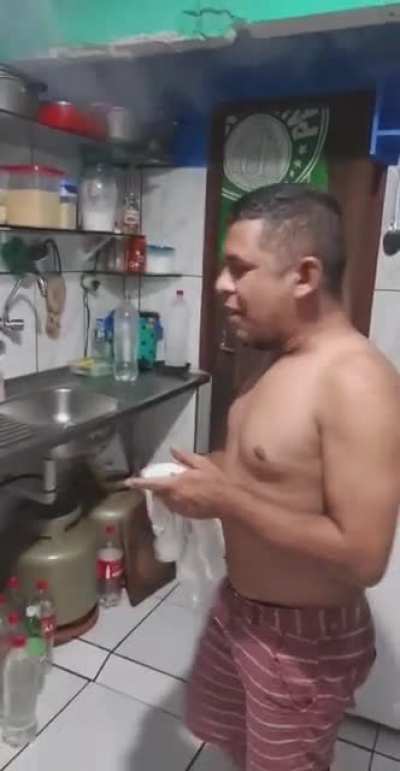 Pouring Water Into a Pot of Hot Oil