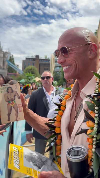 A fan gifts Dwayne Johnson (The Rock) a vintage wrestling magazine with his grandfather Peter Maivia on the cover.