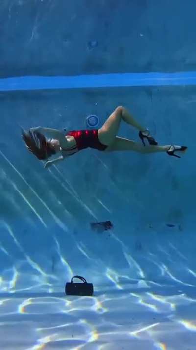 This lady in heels is walking underwater