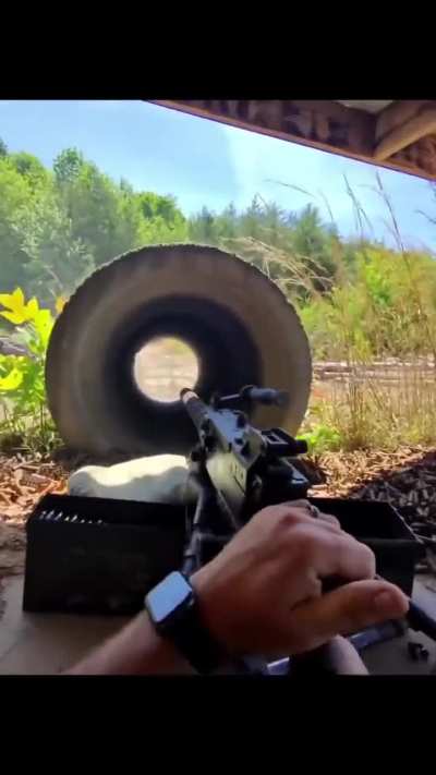 Firing a machine gun through a giant concrete culvert acts as a massive improvised suppressor
