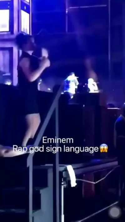 A woman doing "rap god" in sign language