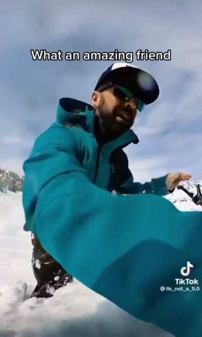 Guy lifts a 400 pound snowmobile off of his friend