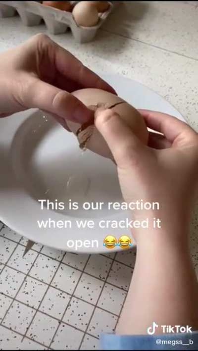 Cracking an egg open to find another egg