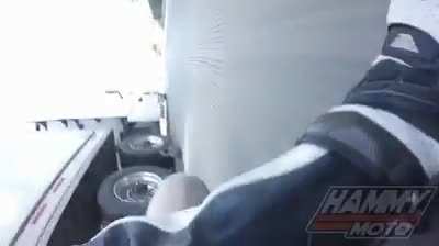 Man loses control on motorcycle and slides underneath a moving semi.