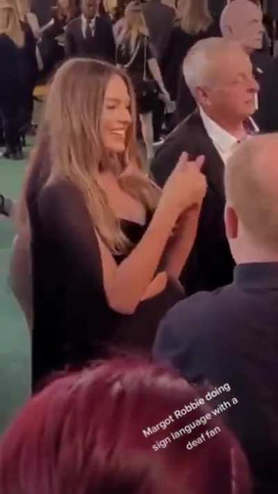 Margot Robbie communicating with a hearing impaired fan