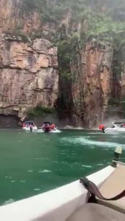 Riding boats near old rock structures