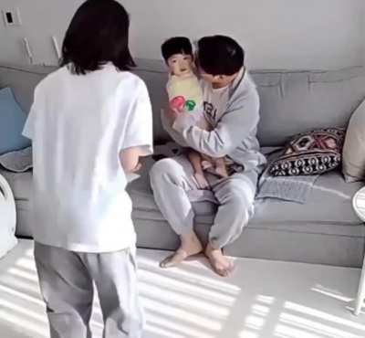 Parents watching their kid take his first steps